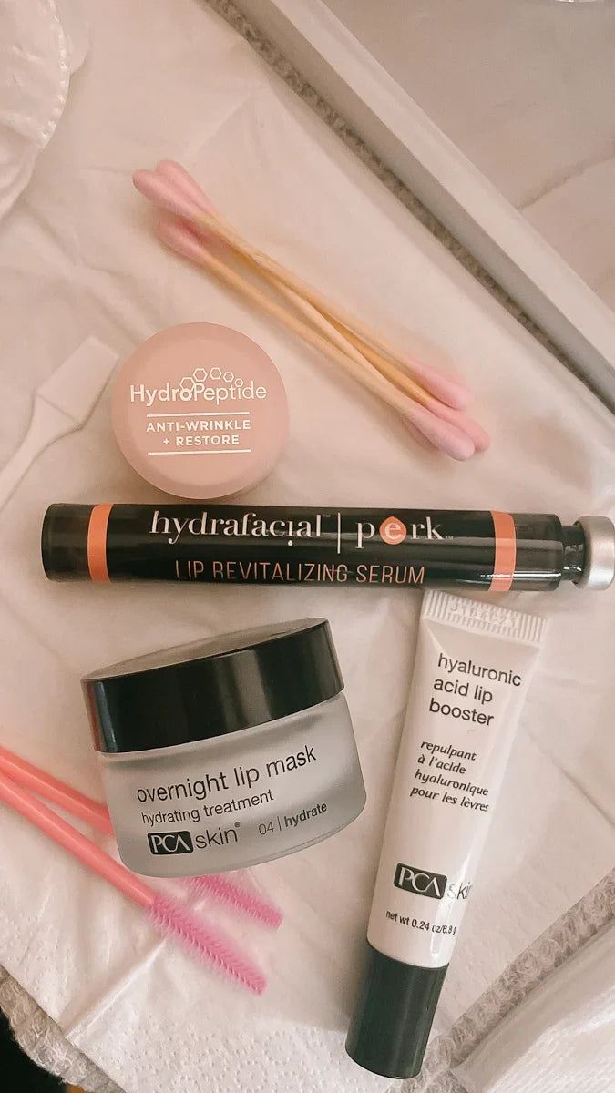 lipcare products on a table. hydrafacial lip perk, pca lip mask, and pca lip booster balm