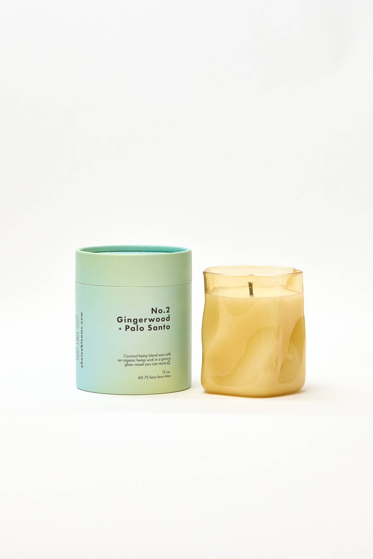 Candle with a green container labeled 'No.2 Gingerwood Palo Santo' on a white background
