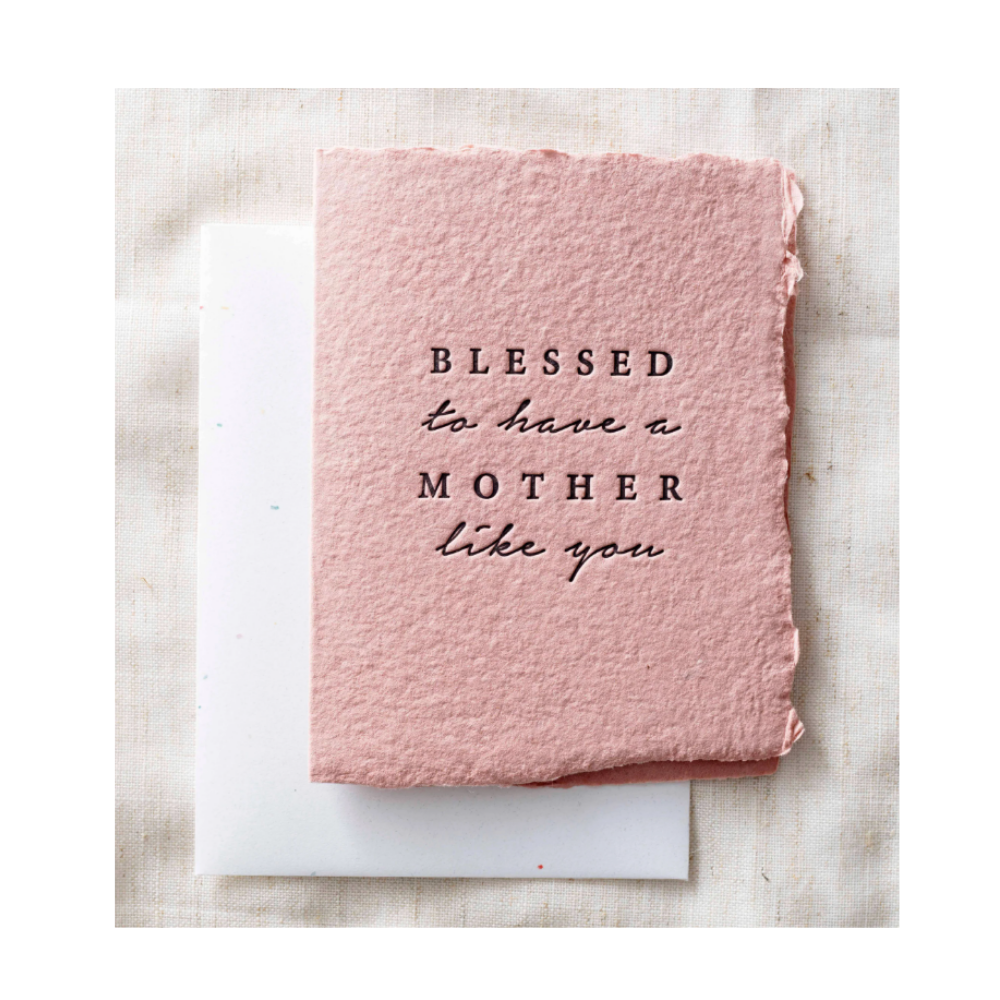 Pink card with 'Blessed to have a mother like you' text on a textured surface