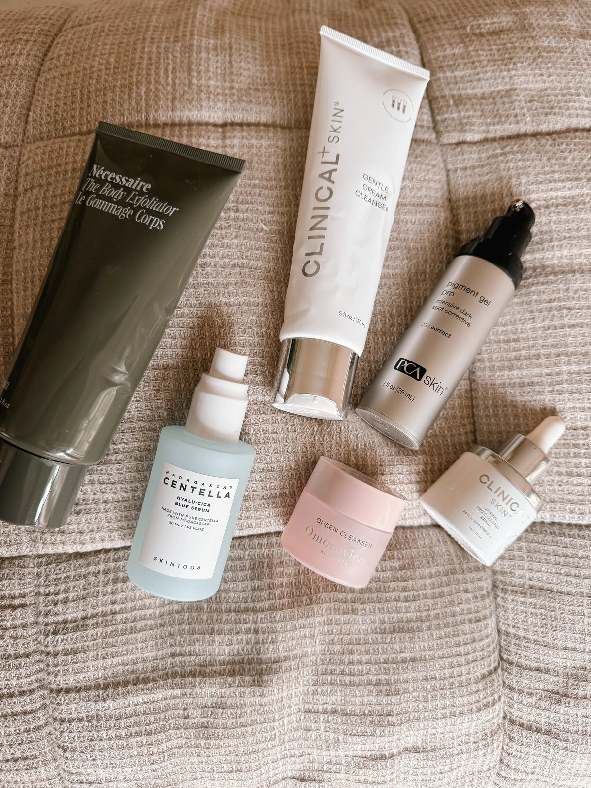 A collection of empty skincare products ft.  Necessaire, Centrella, Clinical Skin, Omorovicza and PCA Skin