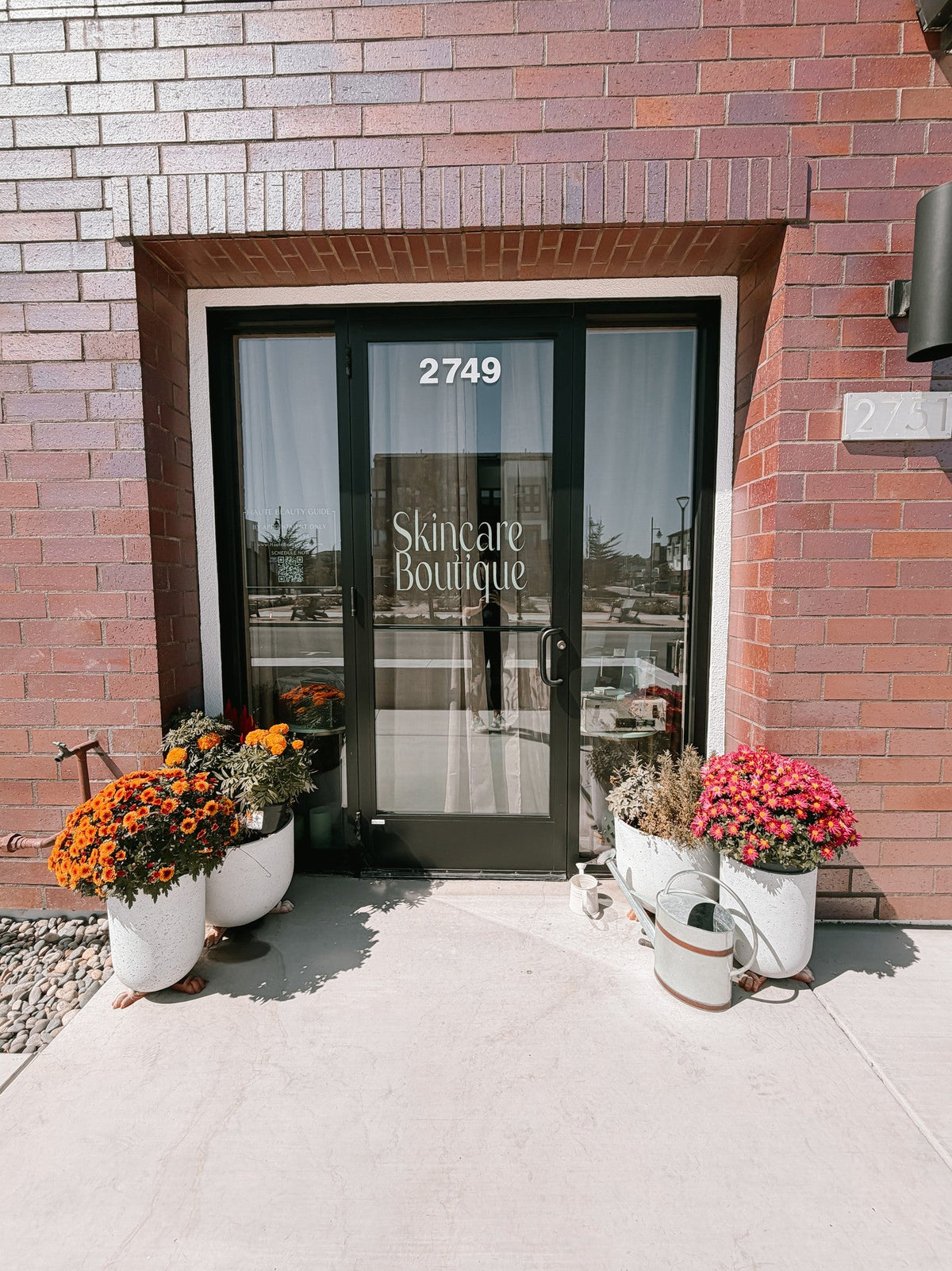 The storefront entrance of Doran Poma Aesthetics' Skincare Boutique at The Dunes in Marina, California — a brick building with 