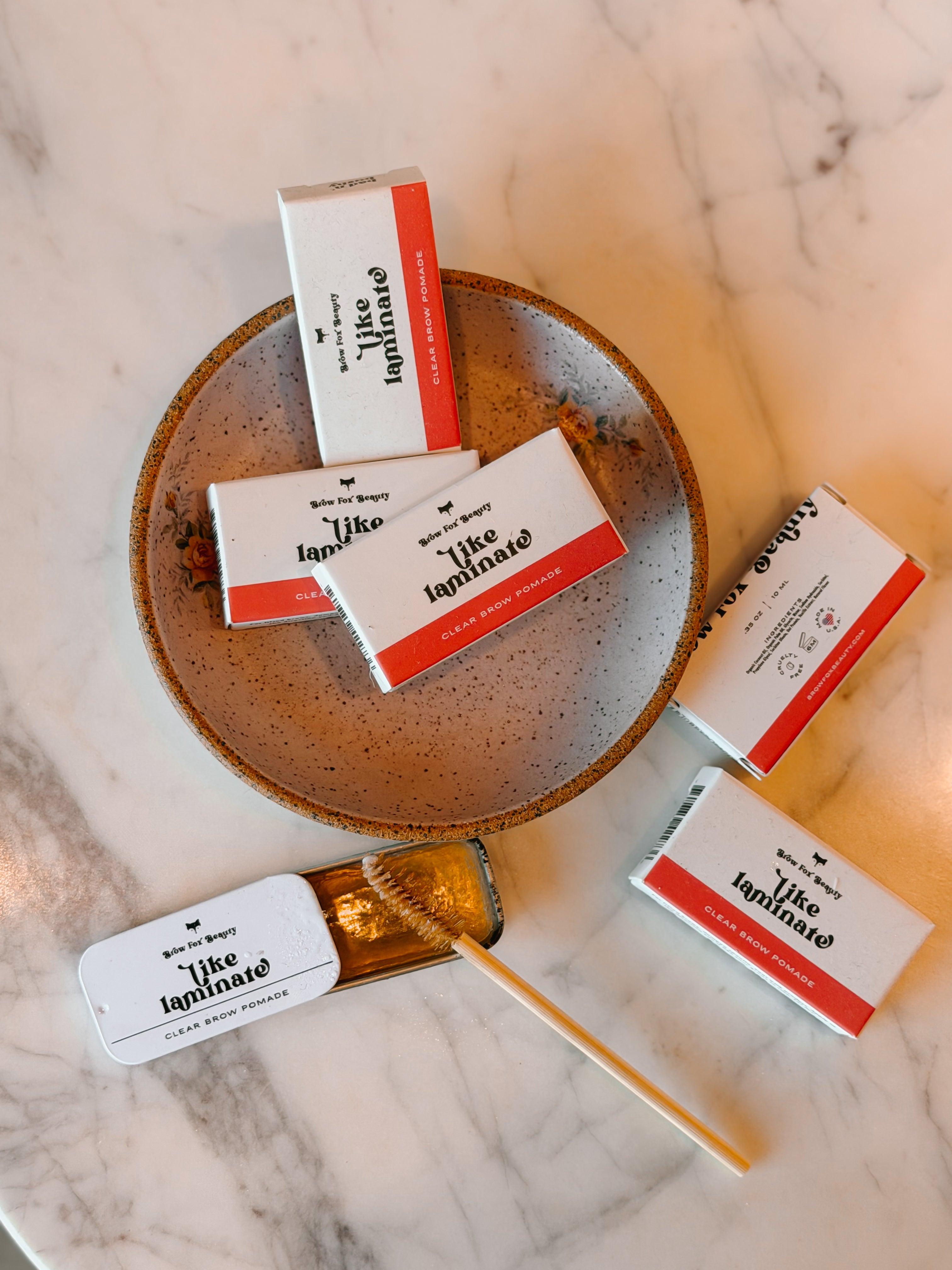 Small boxes with 'like lamination' branding on a marble surface