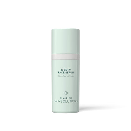 A tall, cylindrical face serum bottle by Marini Skinsolutions in a pale mint green color, featuring a thin light pink band around the middle and black text on the front, set against a clean white background.