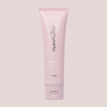 Pink tube of HydroPeptide skincare product on a light blush background