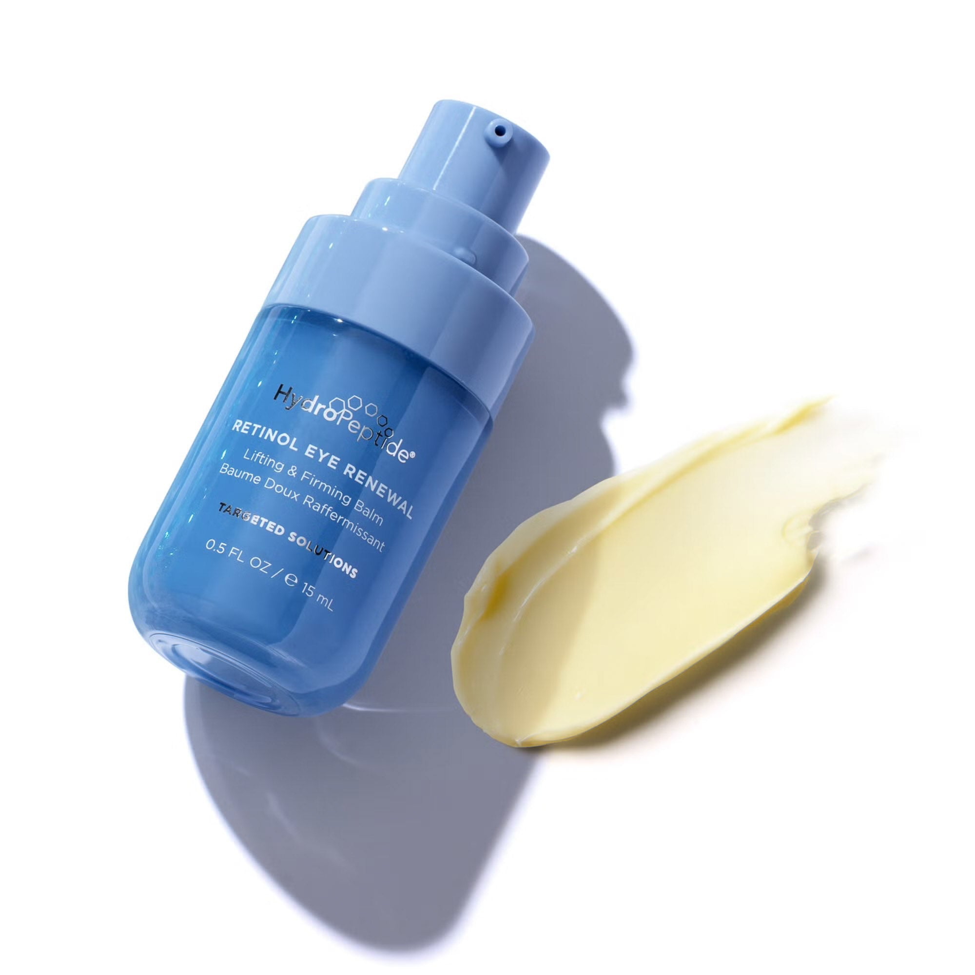 Blue skincare bottle with a yellow cream smear on a white background