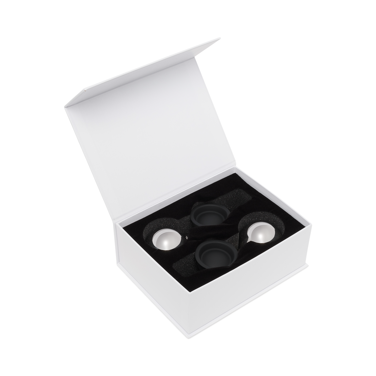 White box with black interior holding three silver circular objects on a white background