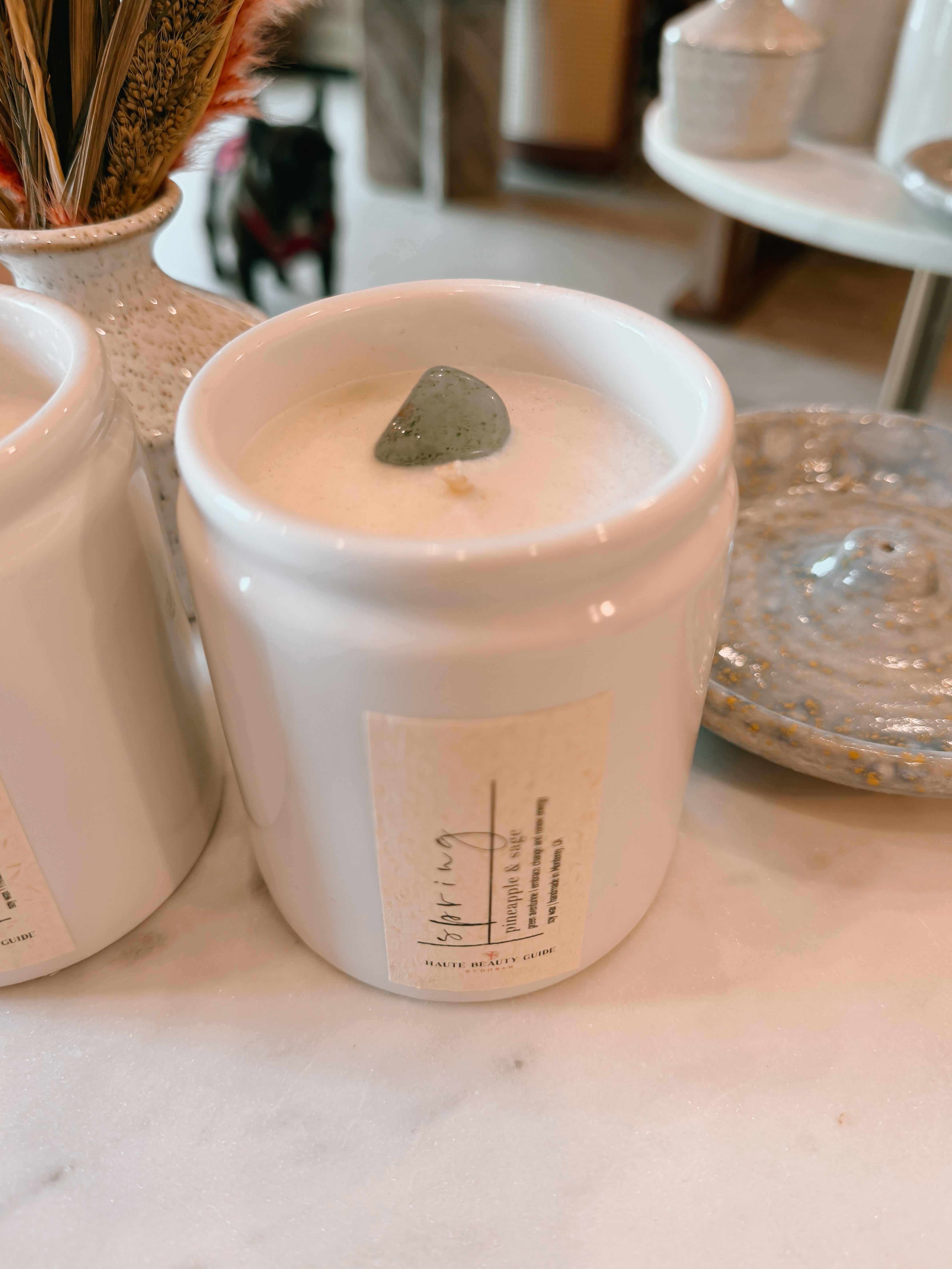 White ceramic container with a small plant on a table
