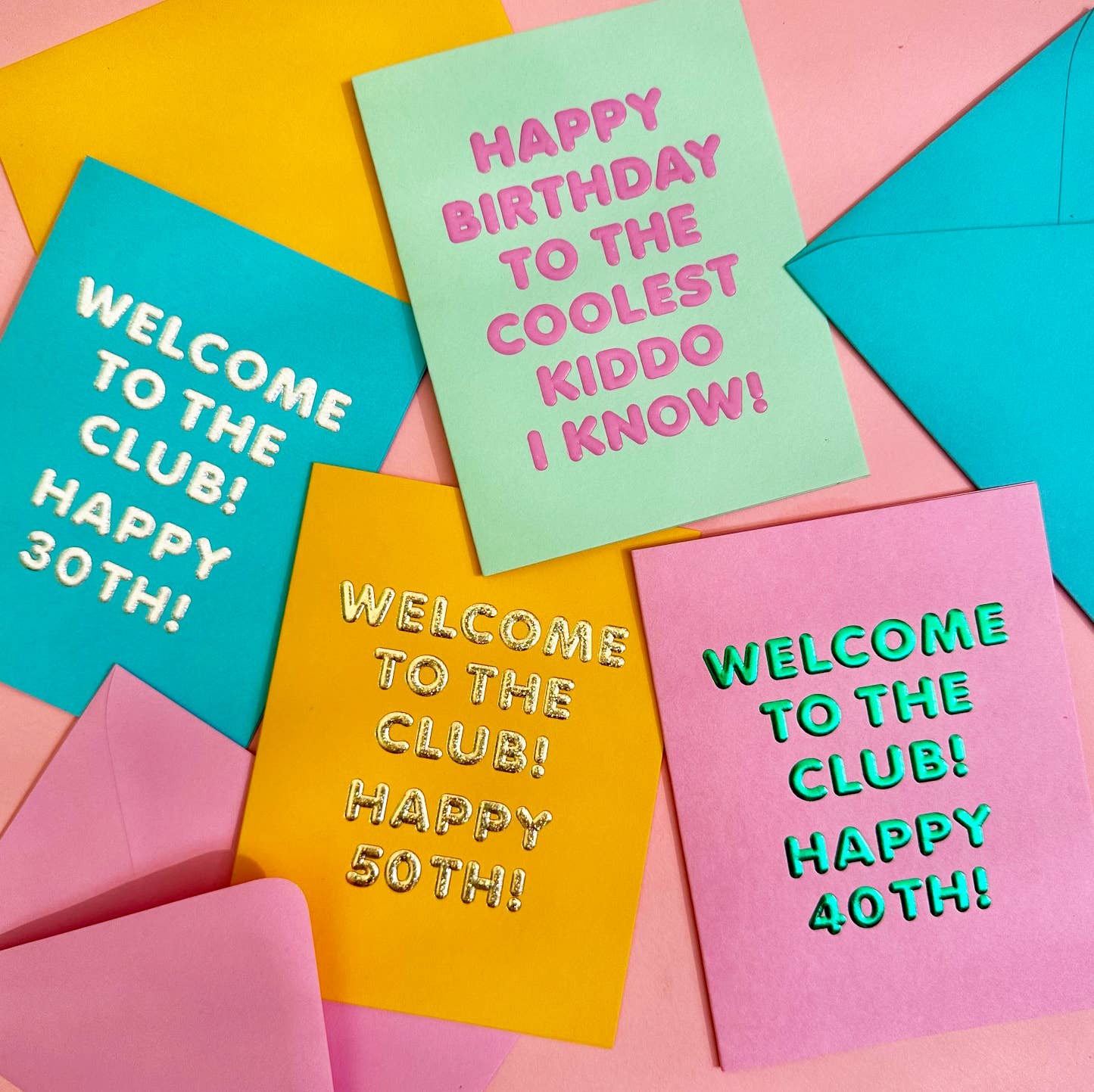 Colorful greeting cards with birthday and membership messages on a pink background