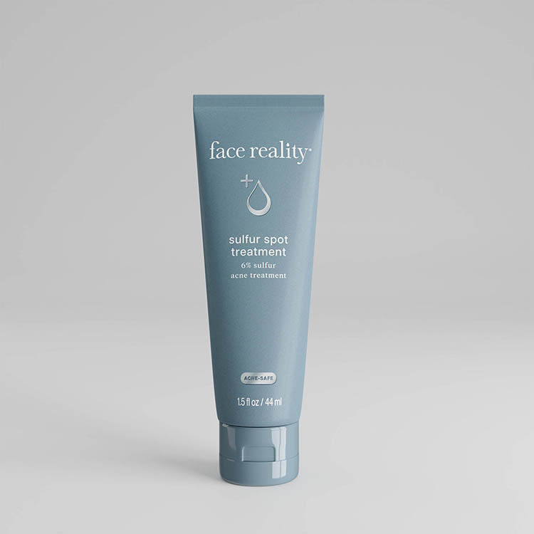 Blue tube of 'face reality' sulfur spot treatment on a gray background